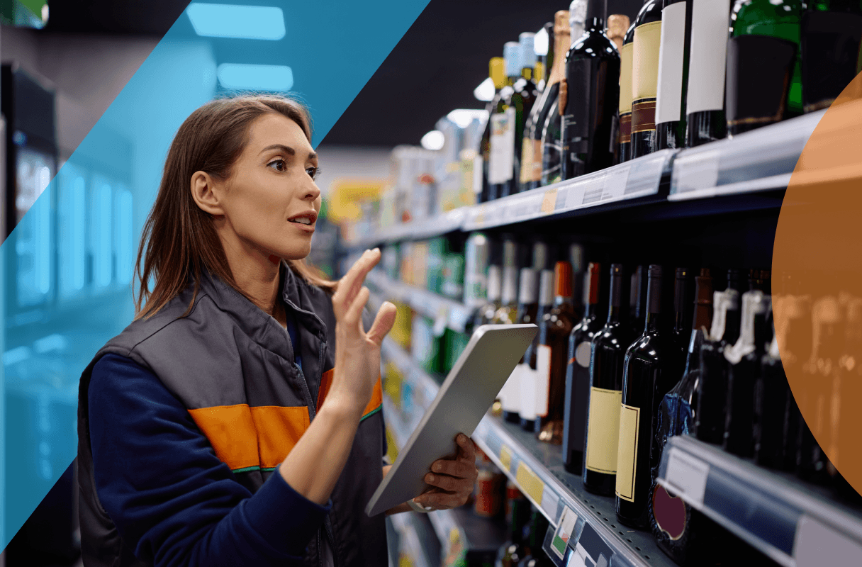 Female liquor store employee in store doing stock take