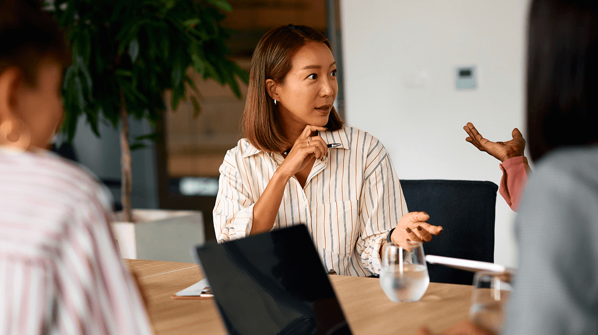Professionals in discussion representing strategic collaboration to integrate AI and automation into customer experience.