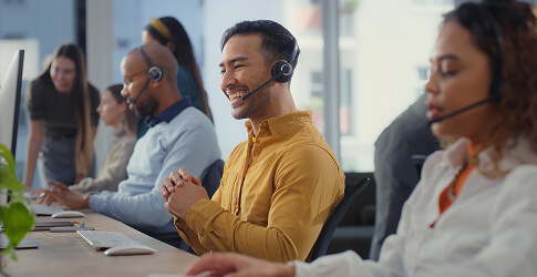 Smiling customer service consultant with a headset in a call centre