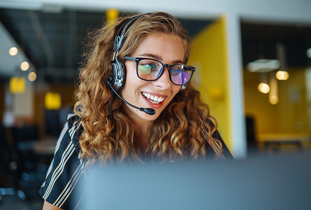 Customer service operator wearing a headset and glasses