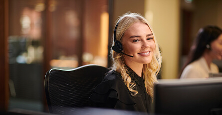 Smiling customer service trainee wearing a headset