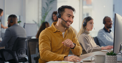 Smiling outbound call centre agent wearing a headset