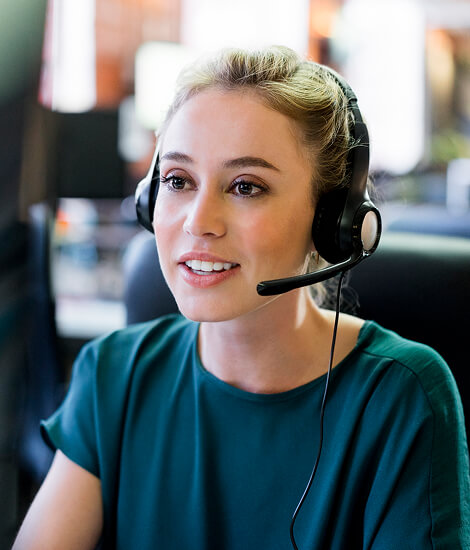 Customer service agent wearing a headset at her desk