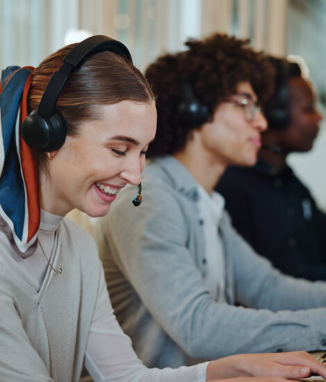 Smiling call centre consultant with colleagues