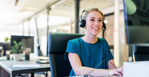 Smiling customer service representative at her desk