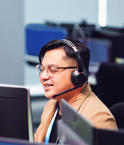 Customer service agents wearing headsets at their desks